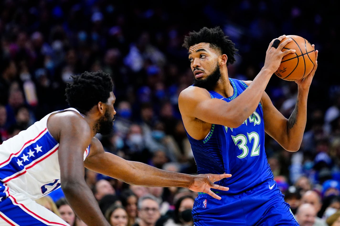 Minnesota Timberwolves' Karl-Anthony Towns, right, tries to get past Philadelphia 76ers' Joel Embiid during the first half of an NBA basketball game, Saturday, Nov. 27, 2021, in Philadelphia. (AP Photo/Matt Slocum)