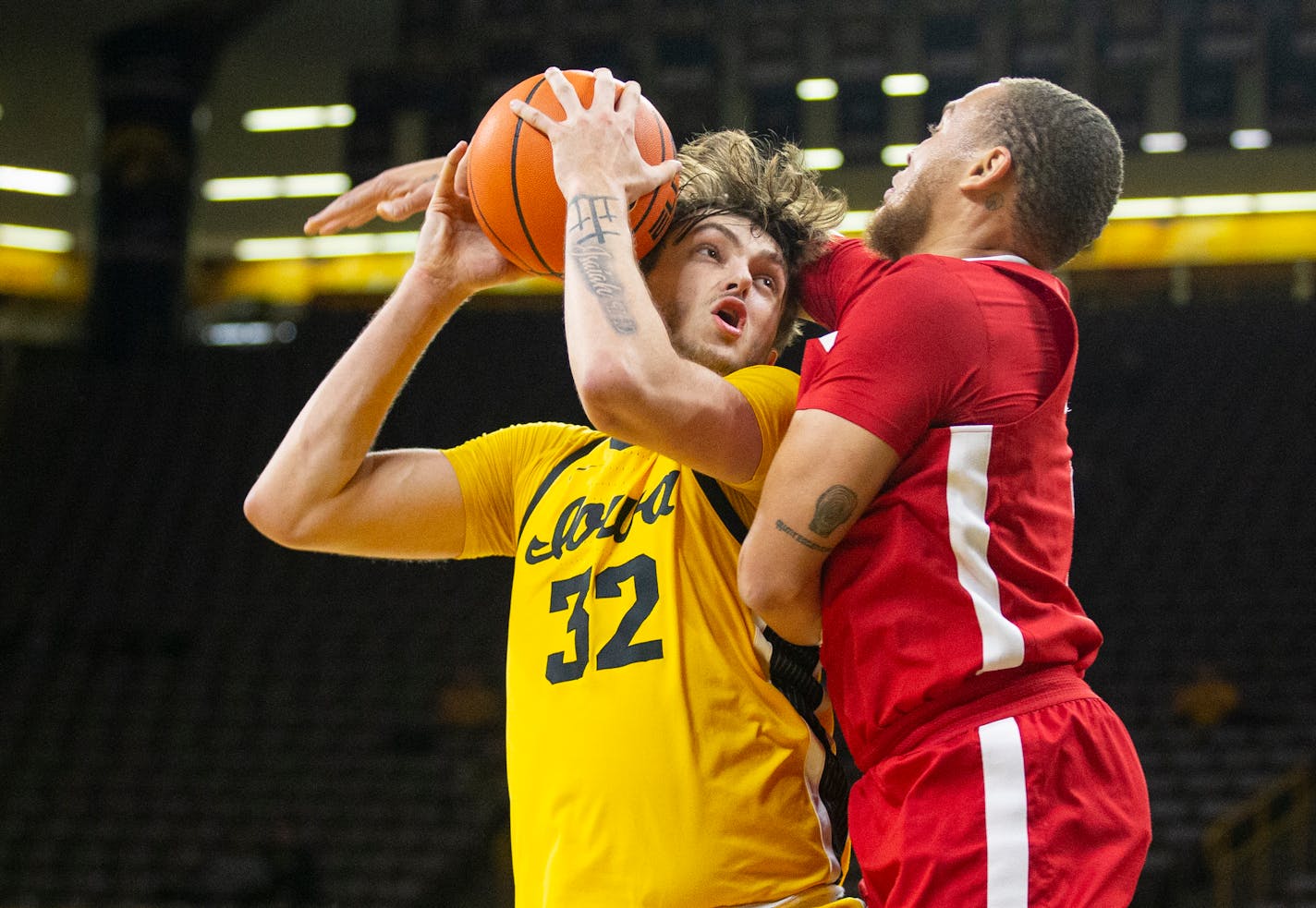 Nebraska guard C.J. Wilcher, right, fouls Iowa forward Owen Freeman (32) during the first half of an NCAA college basketball game Friday, Jan. 12, 2024, in Iowa City, Iowa. (Savannah Blake/The Gazette via AP)