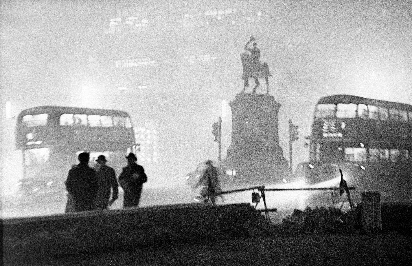 Double-decker buses circle the Prince Albert statue at Holborn Circus in London, England, in the smog at night on Dec. 6, 1952. The heavy smog, caused by coal-fired heating and burning gasoline in motor vehicles, has claimed 106 lives this year. Over the last four days, 67 lives have been lost with more than a hundred people hospitalized. In the background is the newly-built Daily Mirror building. (AP Photo) ORG XMIT: APHS110