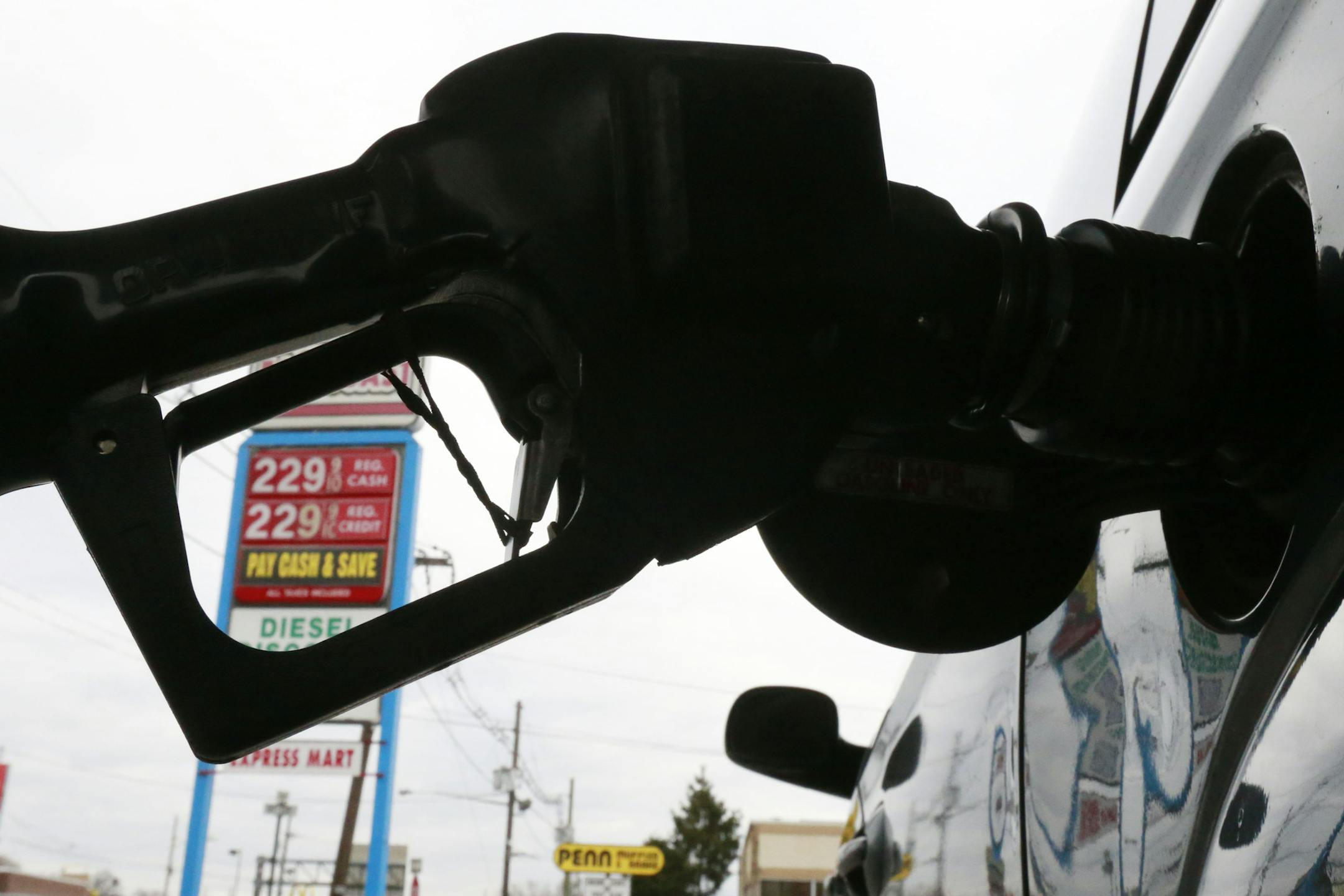 FILE - In this Dec. 18, 2014 file photo, gas is pumped into a car at the Eastcoast filling station in Pennsauken N.J.