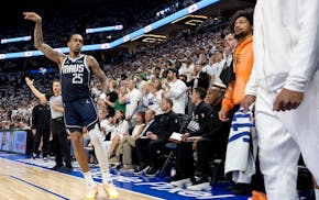 P.J. Washington (25) of the Mavericks looks at the Timberwolves bench after hitting a three-pointer in the fourth quarter.