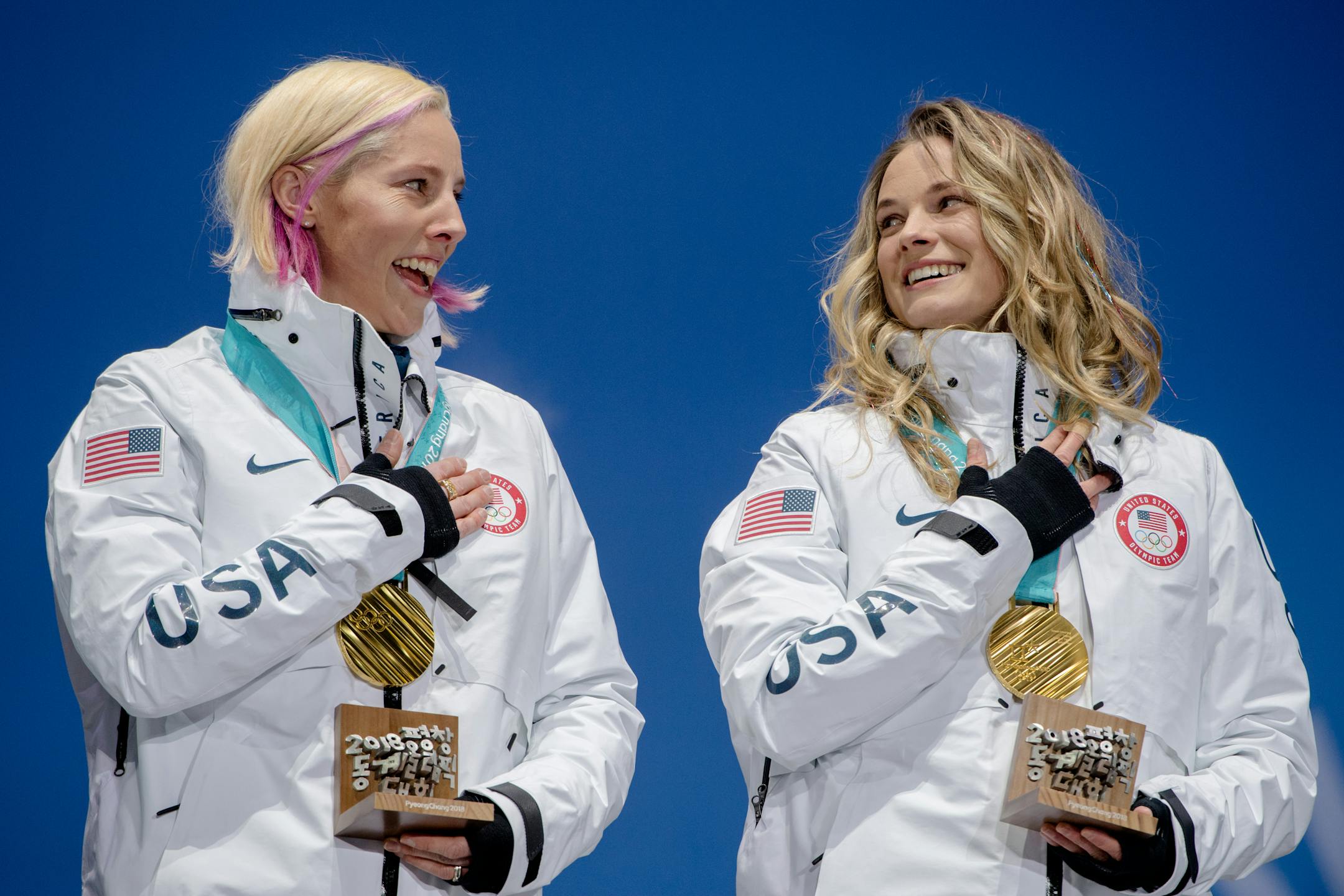 U.S. skiers Kikkan Randall, left, and Jessie Diggins of Afton, Minn., after winning the gold in the team sprint in Pyeonchang, South Korea, on Thursday. Theirs was the first medal by American women in cross-country skiing, and the first gold by an American in that discipline.