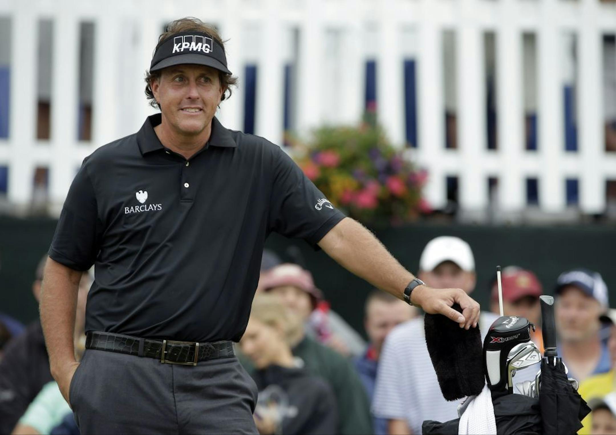 Phil Mickelson smiles as he waits for play to resume after a weather delay during the first round of the U.S. Open golf tournament at Merion Golf Club, Thursday, June 13, 2013, in Ardmore, Pa.