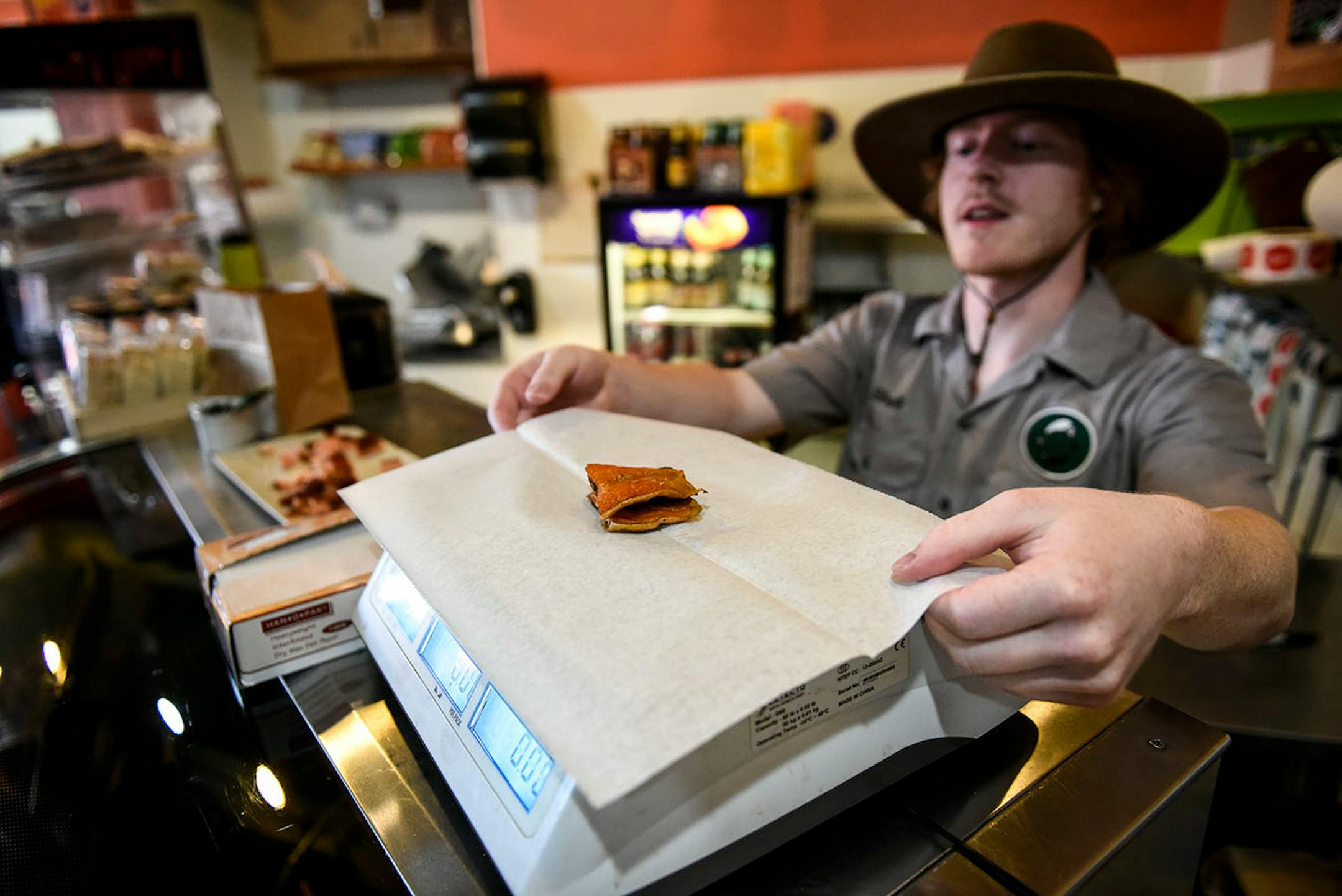 Northern Waters Smokehouse employee Kjell Hinkel weighed a pair of salmon tails for a customer Thursday afternoon.