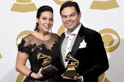 Kristen Anderson-Lopez, left, and Robert Lopez pose in the press room with the awards for best compilation soundtrack for visual media and best song w