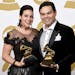 Kristen Anderson-Lopez, left, and Robert Lopez pose in the press room with the awards for best compilation soundtrack for visual media and best song w