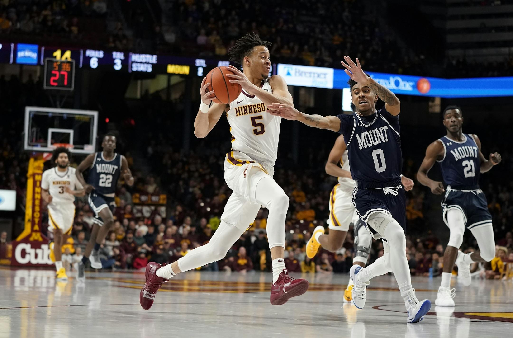 Minnesota guard Amir Coffey (5) charges the basket as Mount St. Mary's guard Vado Morse (0) defends during the first half.