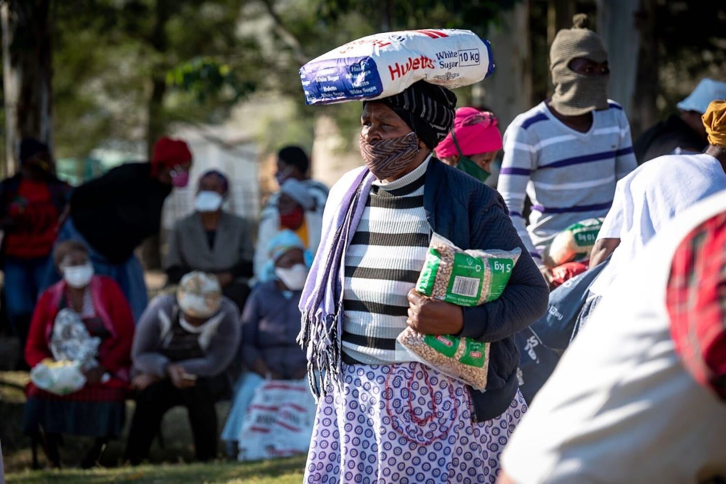 A South African mother carrying her parcel of food. MUST CREDIT: Courtesy of Arm in Arm in Africa