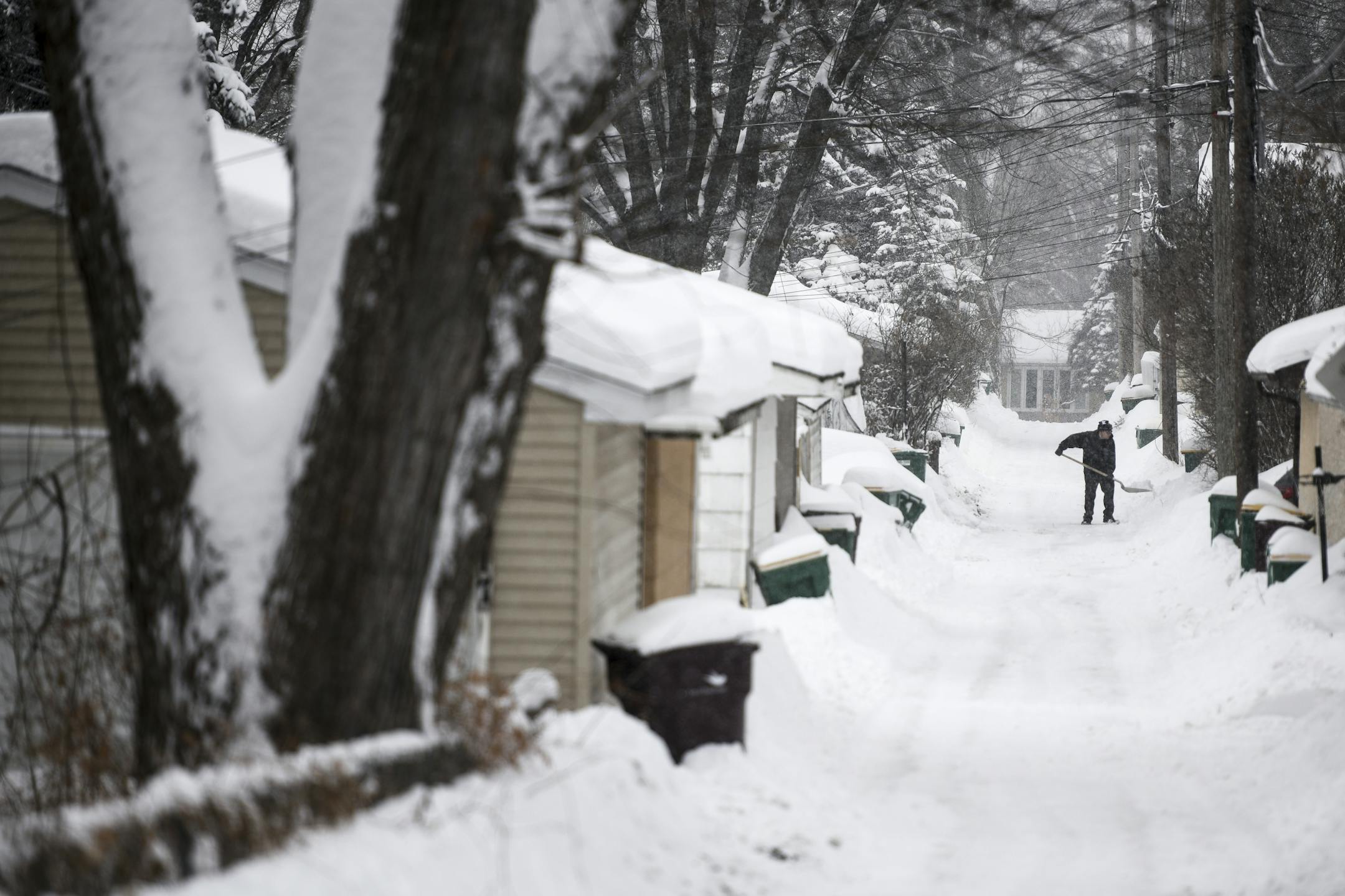 Nathan Ferrell, of Robbinsdale, removed snow from his alley driveway Wednesday afternoon.