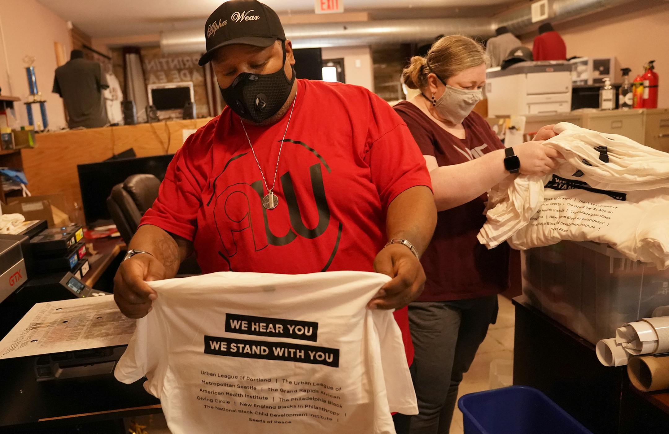 K.B. and Katie Brown own Wolfpack Promotionals on W. Broadway in Minneapolis. The business is still recovering from the riots earlier this year.