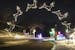 A slow camera shutter speed shows the full moving reindeer arch as a car drives through at the Holiday Lights in the Park at Phalen Park in St. Paul, 