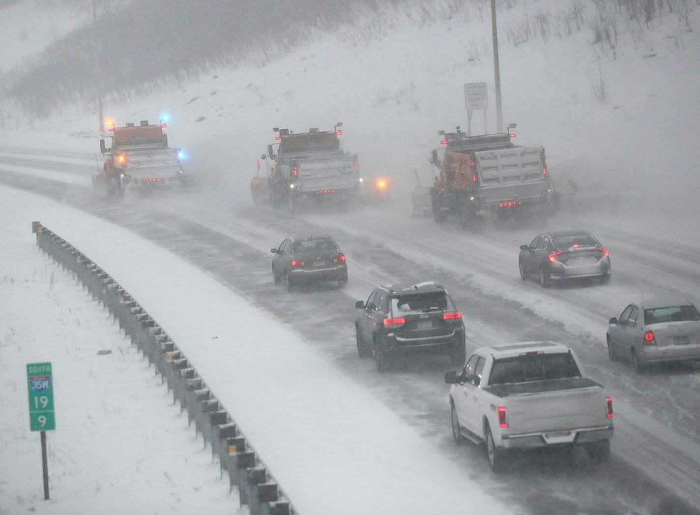 Traffic creeps behind snowplows heading south on I-35W in Minneapolis during an early 2020 snowstorm.