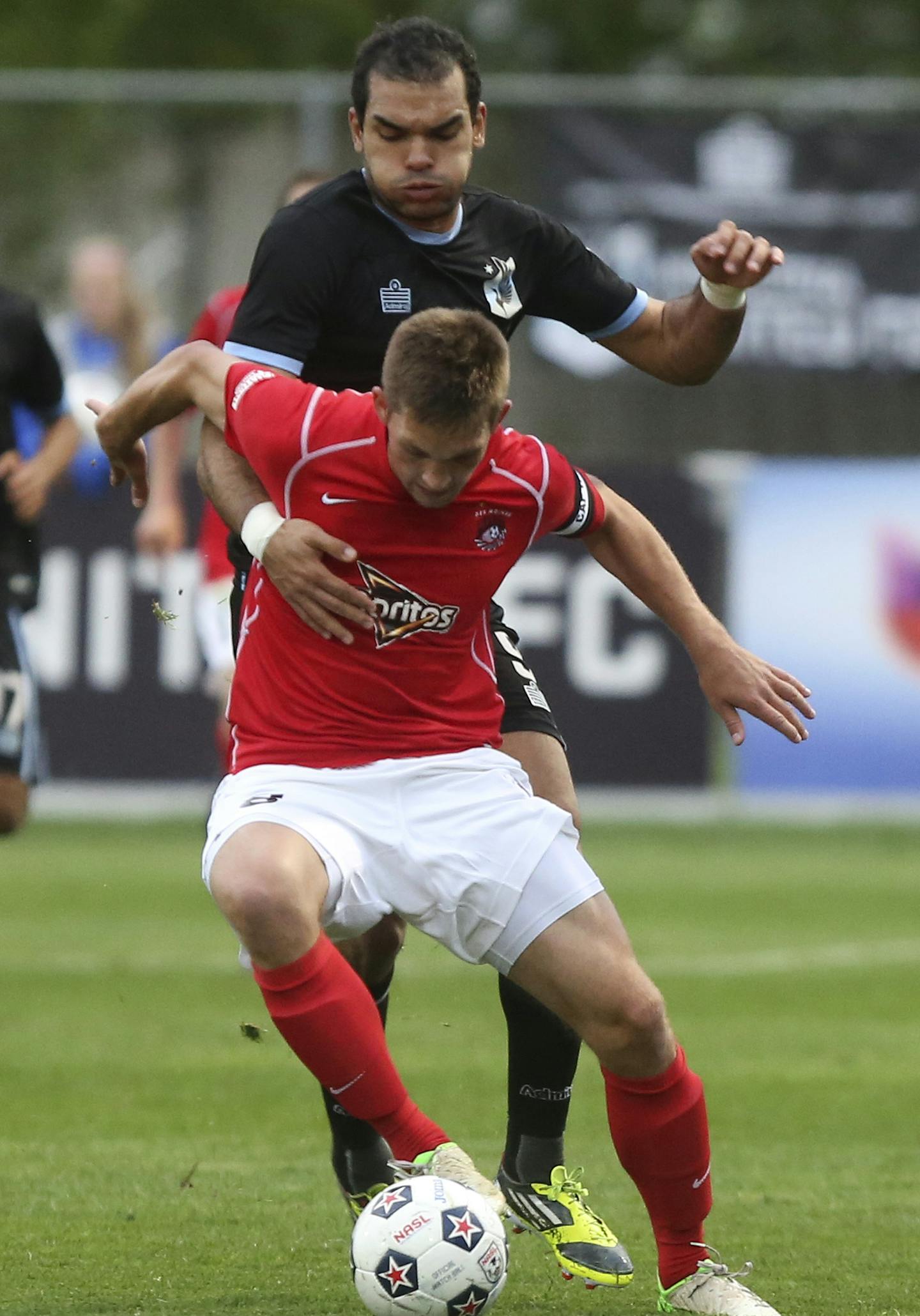 Minnesota United's Pablo Campos tried to move Des Moines Menace's Brandon Fricke off the ball during the first half at Elizabeth Robie Stadium in St. Paul, Min., Tuesday, May 21, 2013 ] (KYNDELL HARKNESS/STAR TRIBUNE) kyndell.harkness@startribune.com