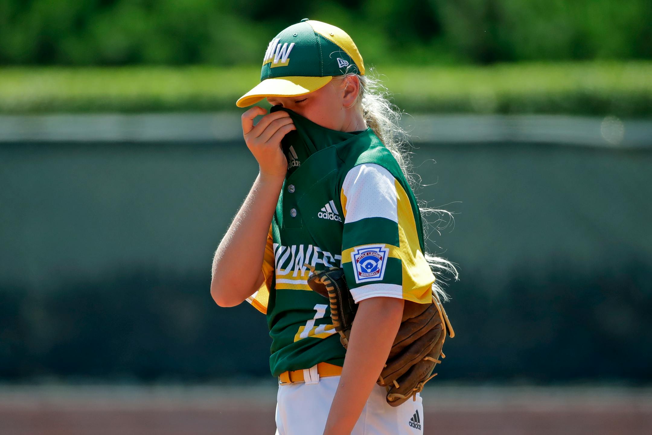 Coon Rapids, Minnesota's Maddy Freking collects herself during a third inning pitching change in a baseball game against South Riding, Virginia at the Little League World Series tournament in South Williamsport, Pa., Sunday, Aug. 18, 2019. Virginia won 11-0. (AP Photo/Gene J. Puskar)