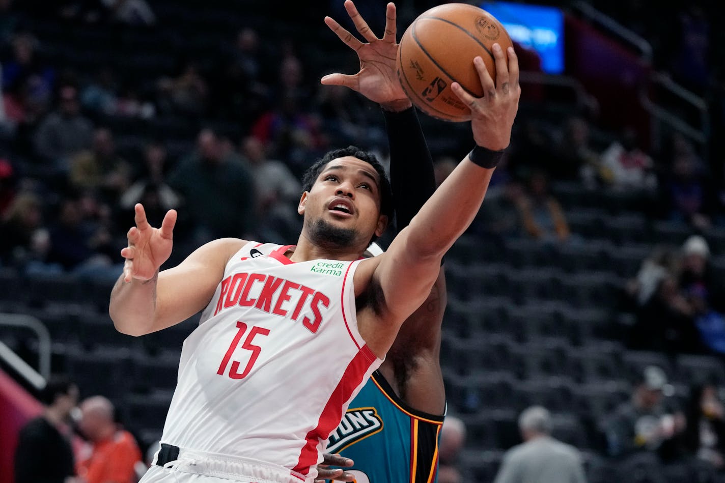 Houston Rockets guard Daishen Nix (15) makes a layup during the second half of an NBA basketball game against the Detroit Pistons, Saturday, Jan. 28, 2023, in Detroit. (AP Photo/Carlos Osorio)