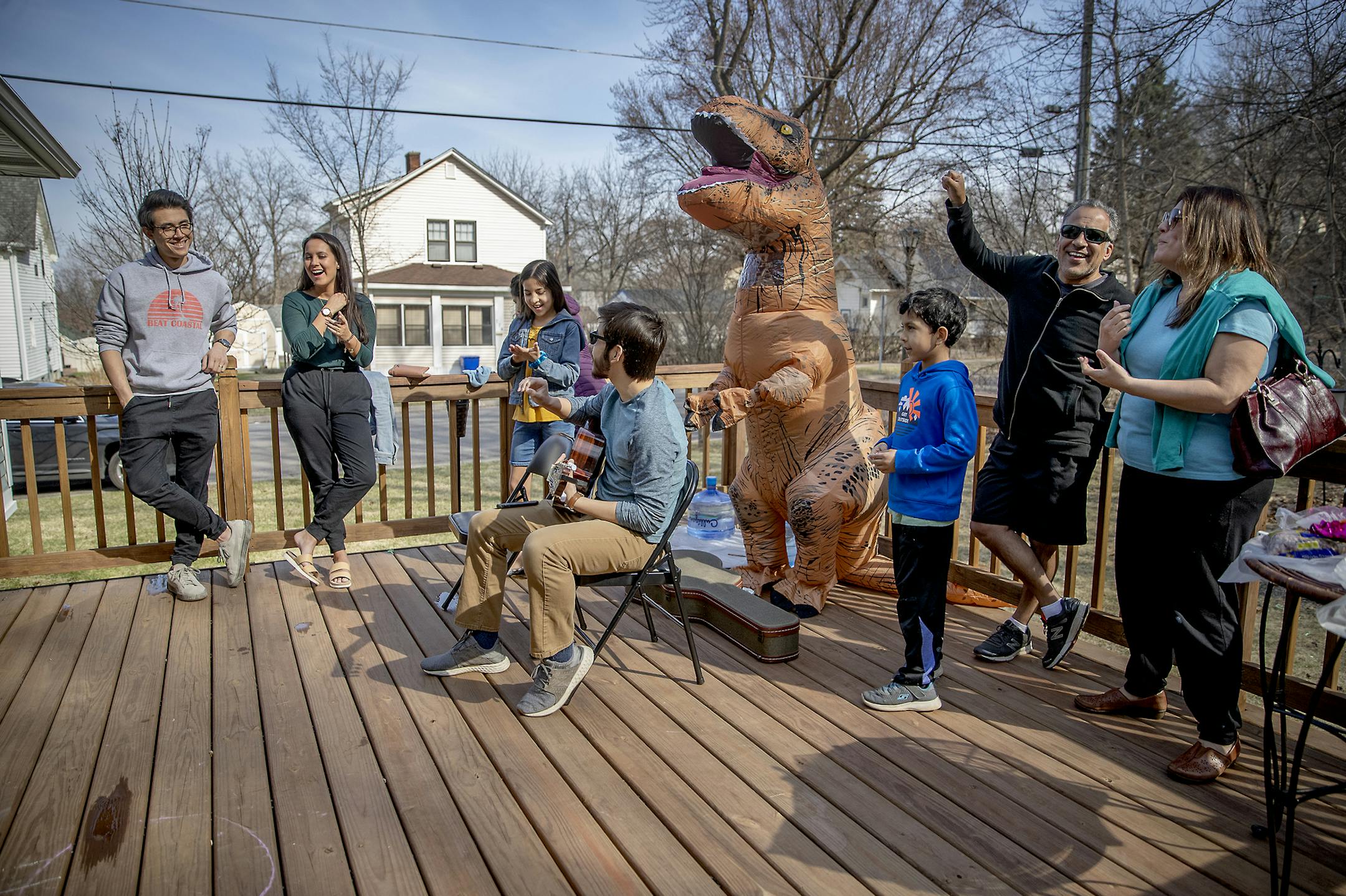 Tizoc and Avenna Rosales, right, and their children, celebrated a birthday for his father Francisco Rosales, who turned 74, Saturday, April 11, 2020 in St. Paul, MN. Francisco Rosales, who has a weakened immune system, was given three birthday parties on his deck from his three children and their families, which include 14 grandchildren. "Had it not been for COVID-19, this yard would be full of people hitting a piñata, dancing, and grilling out," said Ramona Rosales. ] ELIZABETH FLORES 