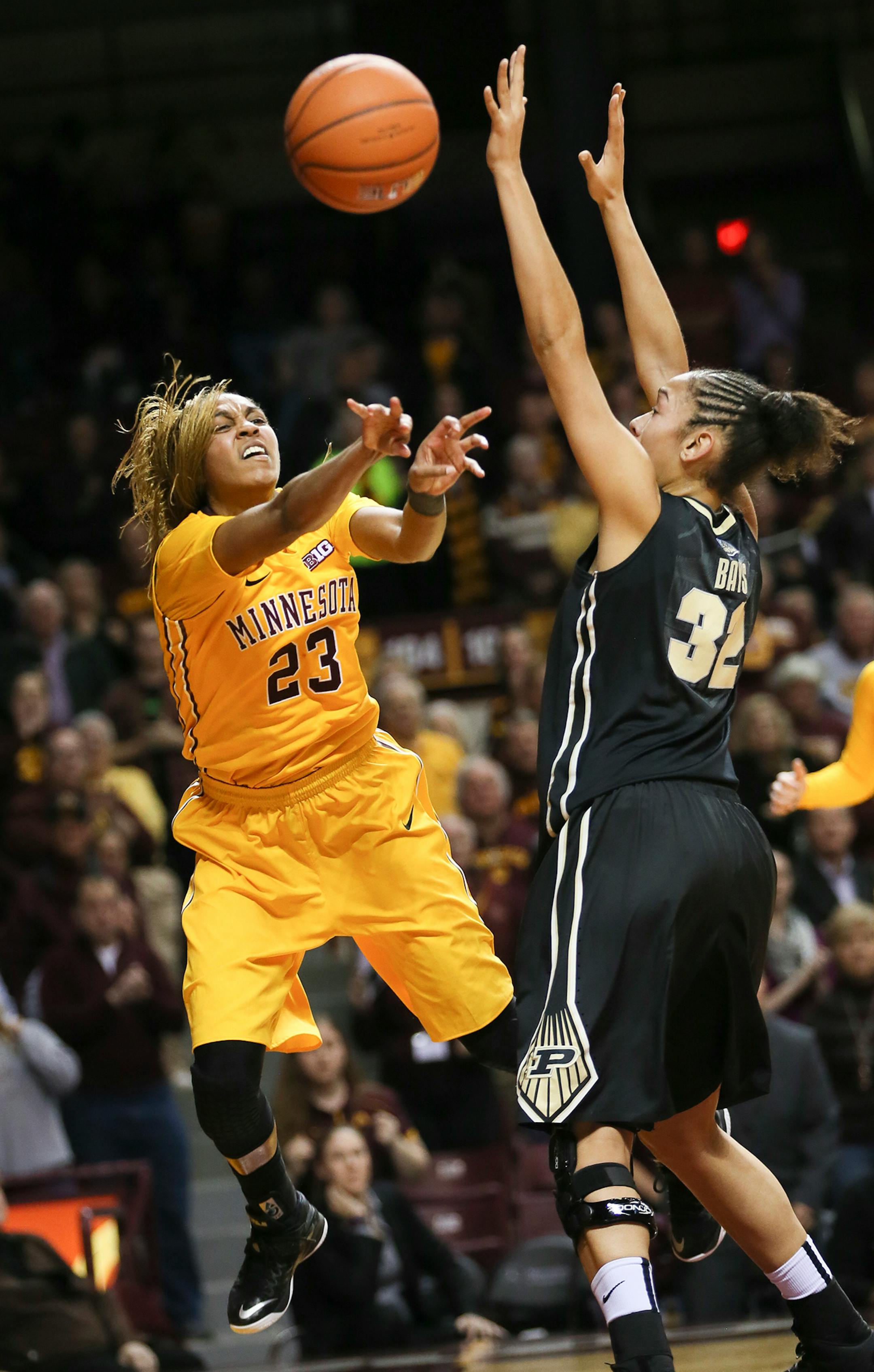 Gophers Shae Kelley passed the ball past Purdue's Whiteney Bays in overtime. The Gophers lost to Purdue 90-88. ] RENEE JONES SCHNEIDER • reneejones@startribune.com Minnesota Gophers women's basketball verse. Purdue Boilermakers at Williams Arena at the University of Minnesota on Thursday, January 22, 2015 in Minneapolis, Minn.