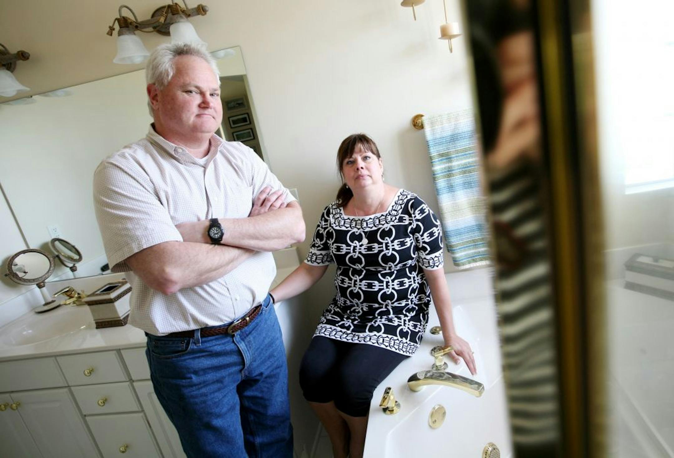Cindy, right, and Rodney Erickson of Savage gave nearly $6,000 in down payment to a remodeling company that went out of business and disappeared, along with their money. They were photographed in the bathroom they had planned to have remodeled June 1, 2012.