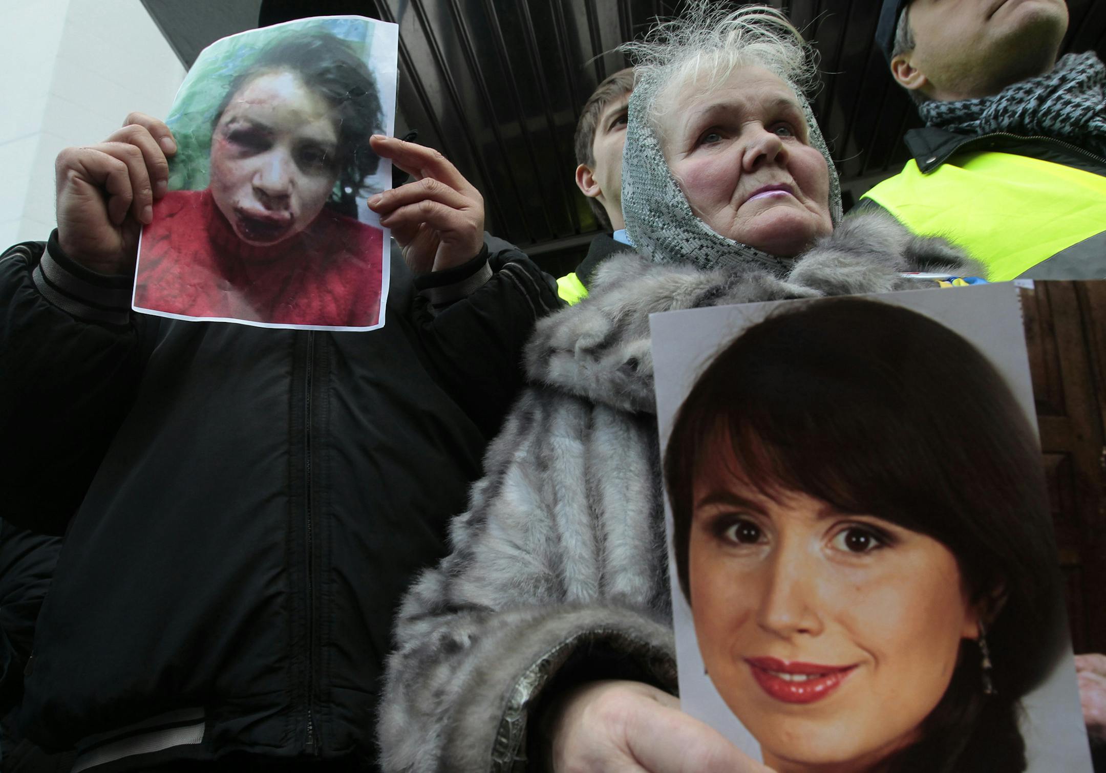 Activists hold the photos of journalist and activist Tetyana Chernovil as they rally outside the Ukrainian Interior Ministry in Kiev, Ukraine, Wednesday, Dec. 25, 2013. Tensions escalated further on Wednesday when a journalist and opposition activist, Tetyana Chernovil, was brutally beaten outside Kiev, hours after publishing a story on the lavish suburban residence that she said belongs to the country's embattled interior minister, a staunch Yanukovych ally. (AP Photo/Sergei Chuzavkov) ORG XMIT