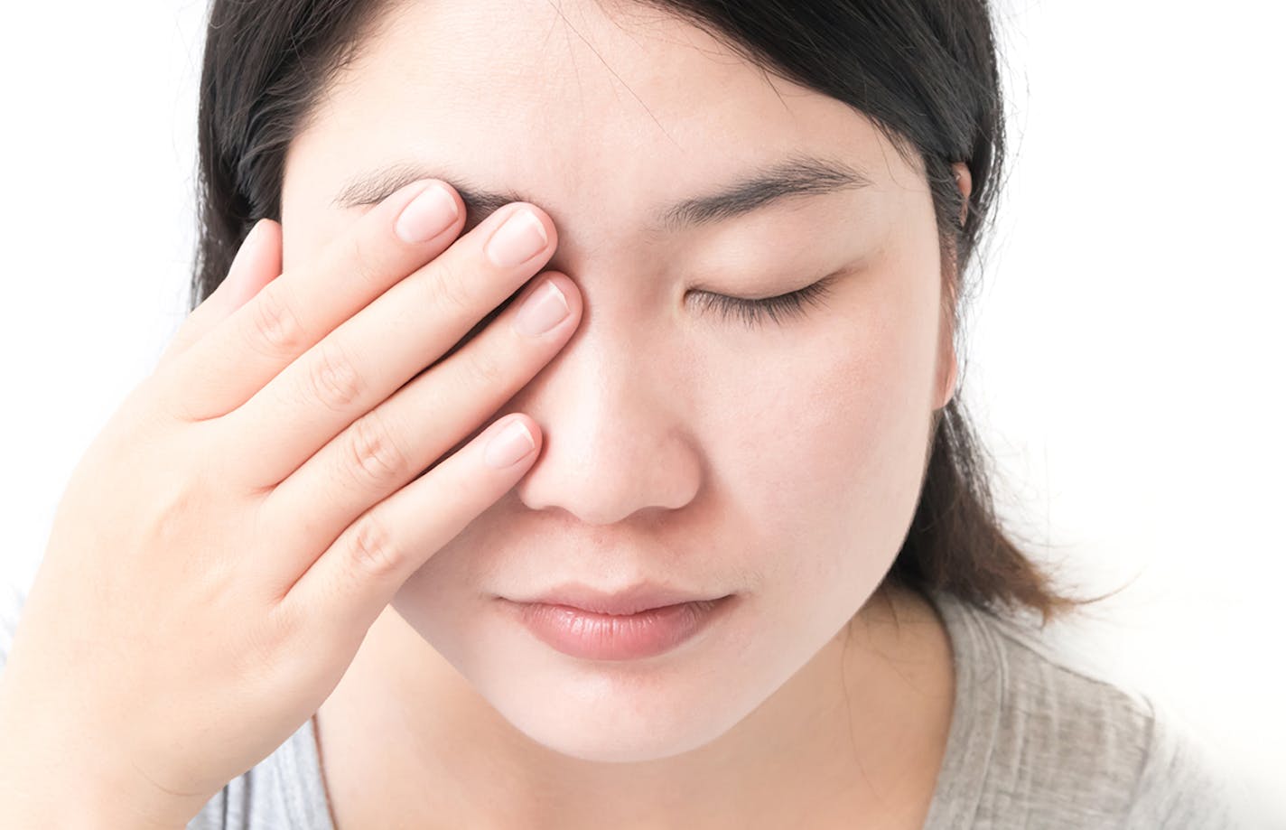 Woman hand closes eyes with eye pain, health care and medical concept