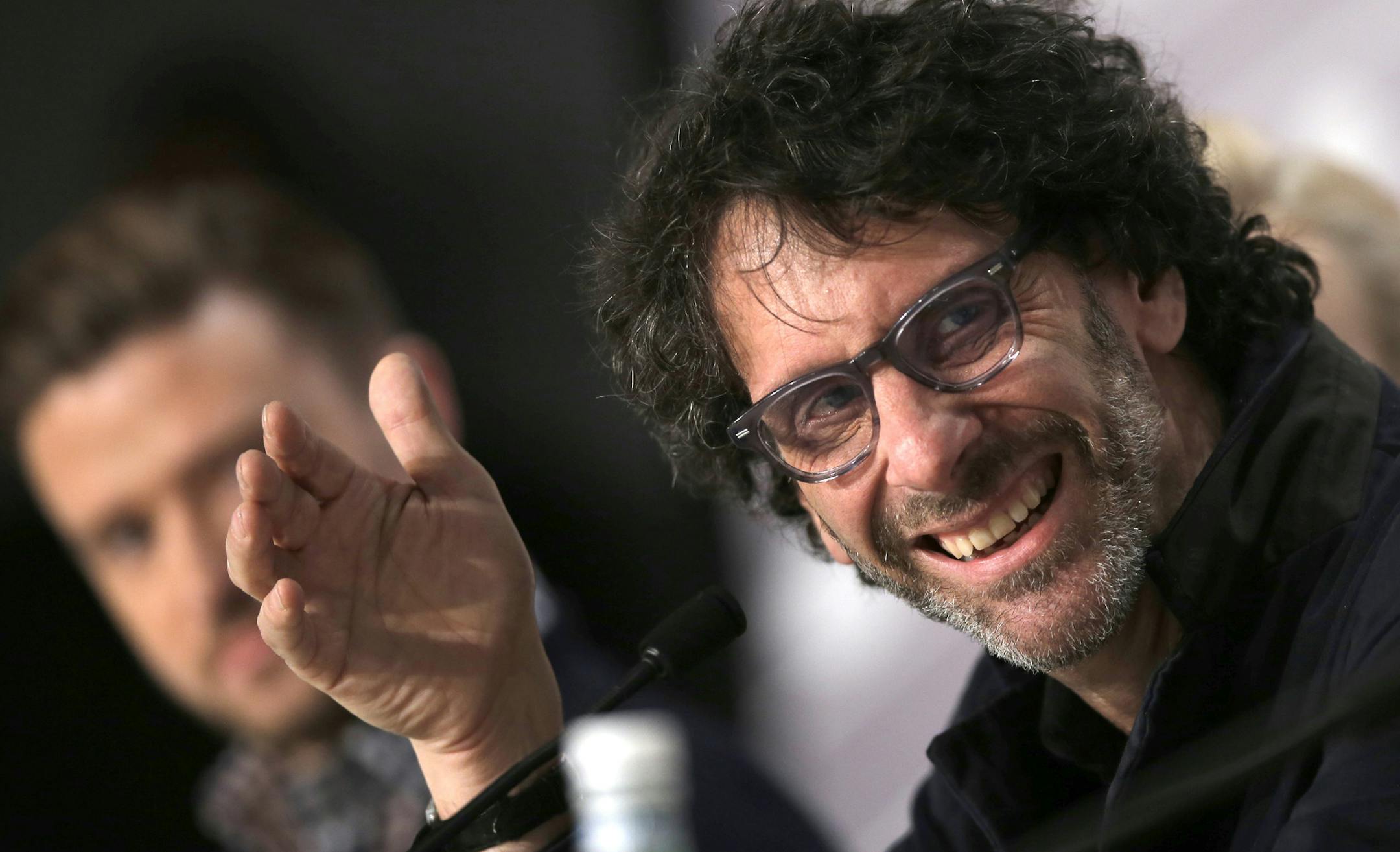 Director Joel Coen, right, speaks during a press conference for Inside Llewyn Davis at the 66th international film festival, in Cannes, southern France, Sunday, May 19, 2013. (AP Photo/Francois Mori) ORG XMIT: MIN2013052213274367