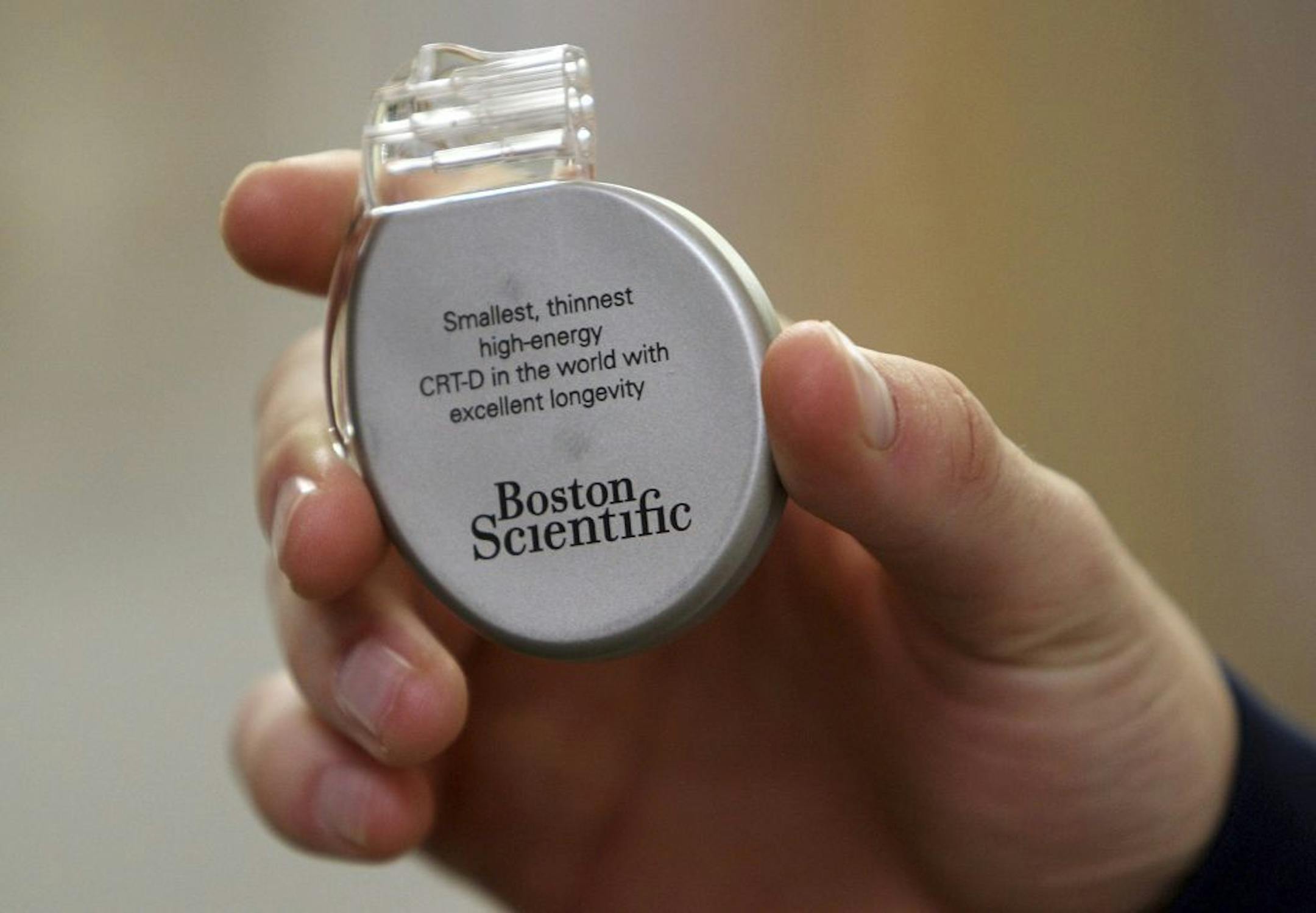 FILE - In this Dec. 7, 2012, file photo, Utah State basketball player Danny Berger holds a defibrillator, like the one implanted in his chest, following a news conference at Intermountain Medical Center in Murray, Utah. Berger collapsed during NCAA college basketball practice and went into cardiac arrest, resulting in a defibrillator being implanted in his chest. Berger ran a mile the other day then did some stairs afterward, just six weeks after he nearly died after collapsing on the basketball