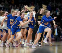 St. Michael-Albertville players celebrate their state championship in 2023.