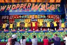 Fairgoers played the Whopper Water game in the Mighty Midway section of the Minnesota State Fair.