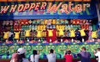 Fairgoers played the Whopper Water game in the Mighty Midway section of the Minnesota State Fair.