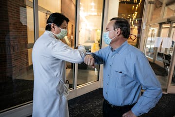 Kevin Manion elbow-bumped with Dr. Benjamin Sun last week at the Minneapolis Heart Institute Foundation. Manion received a heart on Jan. 30 that was r