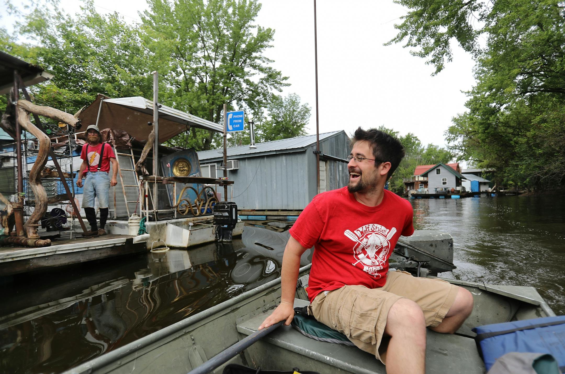 Moses Simon, a Winona boathouse owner, rides on the water at Winona's Latsch Island.