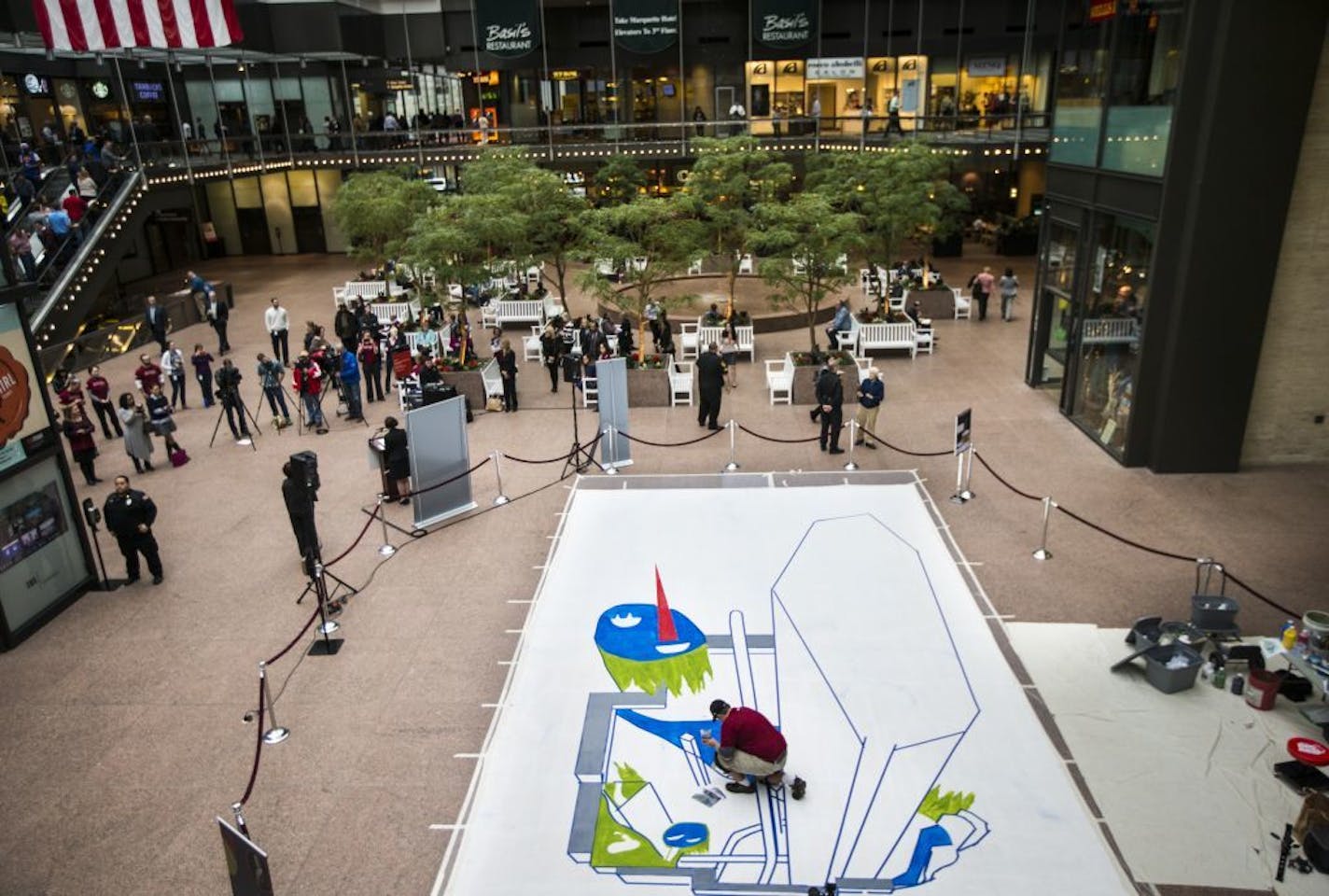 Local muralist Shawn McCann painted a 3D street scene in the plaza at the IDS Center in downtown Minneapolis, Minn. to commemorate The Minneapolis Foundation's Centennial, on Monday, April 6, 2015. The interactive painting will be finished Tuesday afternoon and on display through Friday.