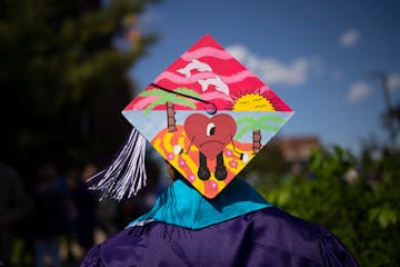 A Southwest grad outside 3M Arena at Mariucci after his commencement ceremony ended and before South High School's began last June.