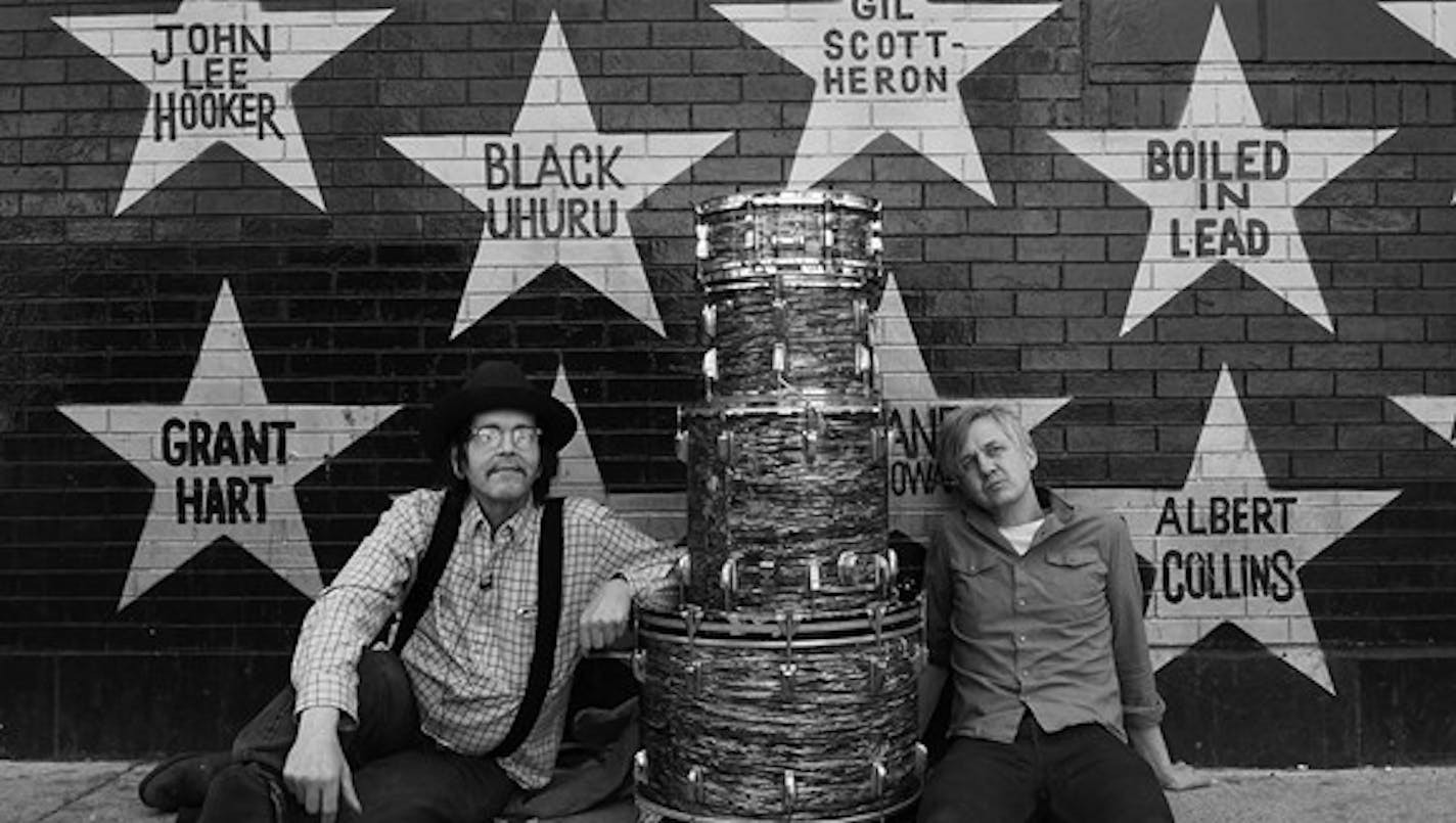 Grant Hart, left, and artist Chris Larson with Hart's old drum kit outside First Avenue and 7th Street Entry.