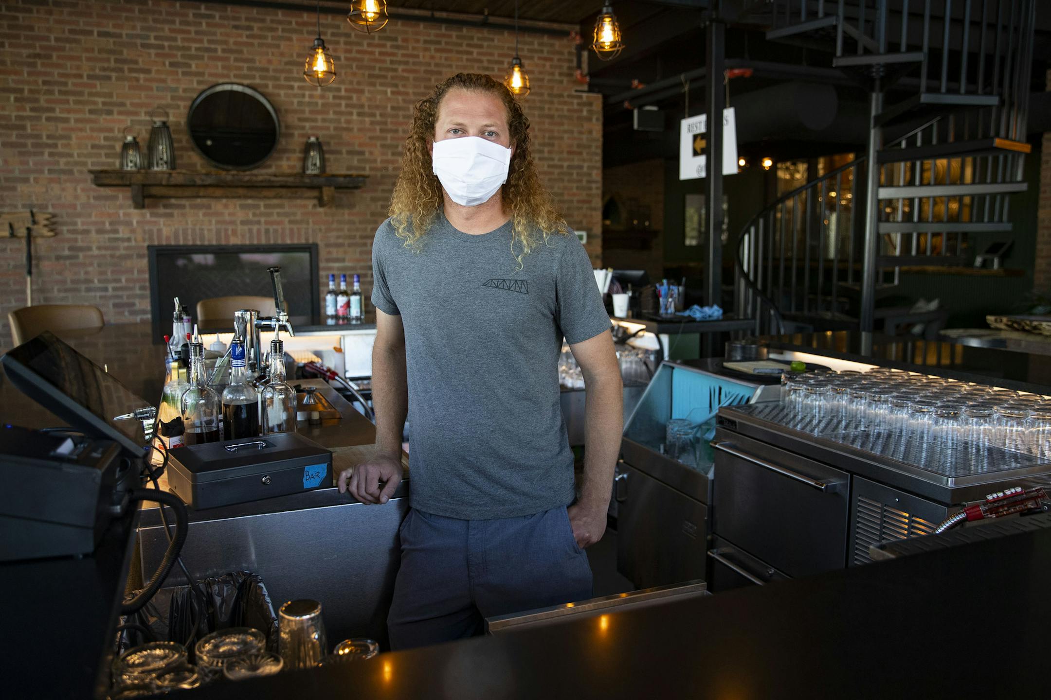 Charlie Fuller, the distiller of Cantilever Distillery in International Falls, MN, posed for a portrait behind the bar on Thursday. ] ALEX KORMANN • alex.kormann@startribune.com Cantilever Distillery and Hotel in International Falls, Minn. opened less than a month ago but has already received a great reception from locals and visitors alike. The hotel is complete with a twelve person hot tub, yoga studio and sauna overlooking a lake.