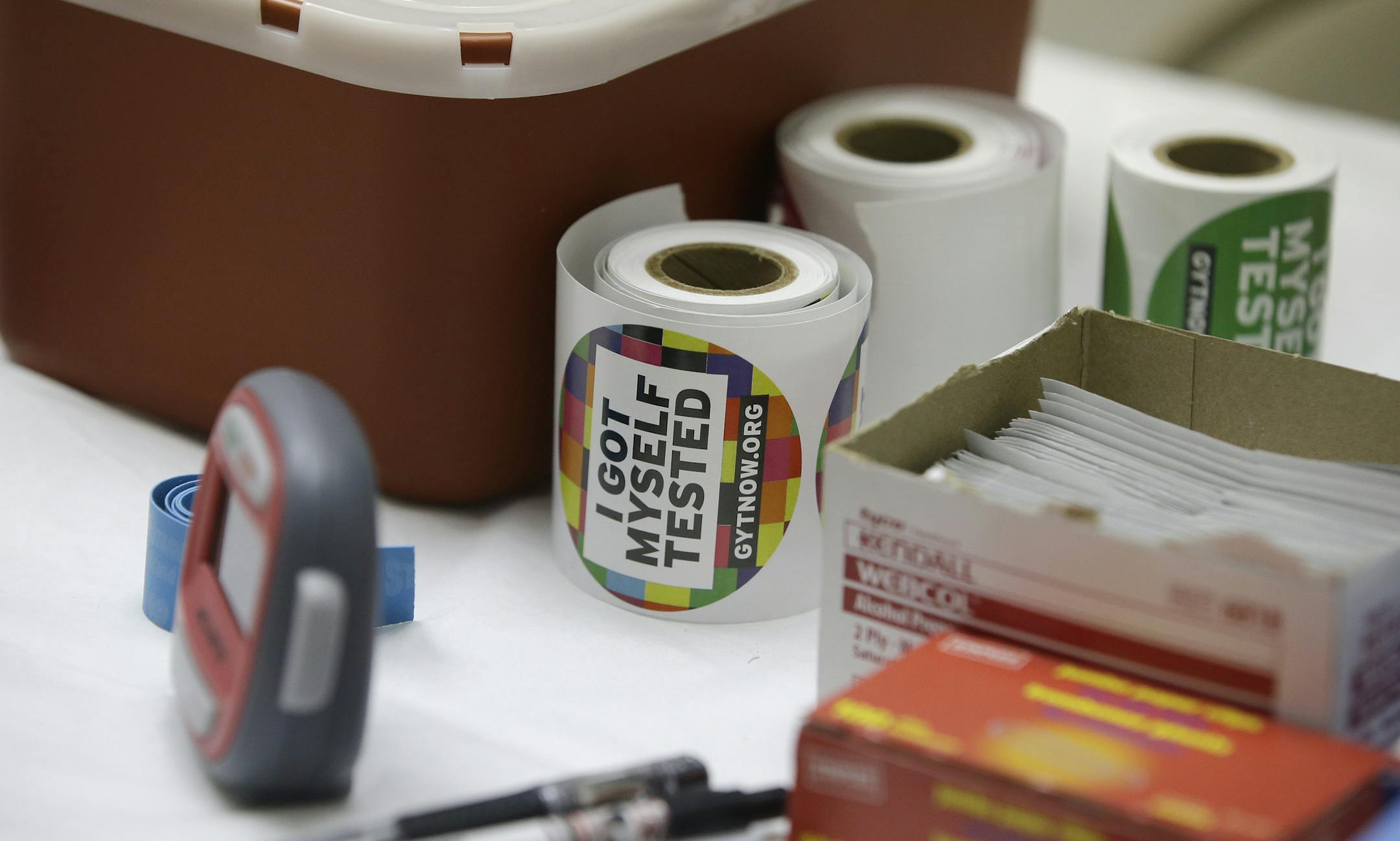 Stickers are given to clients after they get tested for HIV at the One-Stop Shop at the Austin Community Outreach Center, Tuesday, April 21, 2015, in Austin, Ind. Indiana health officials trying to contain an HIV outbreak tied to needle-sharing among drug users are getting helping from specialists from other states in tracking down about 130 additional people who also may be infected. (AP Photo/Darron Cummings)