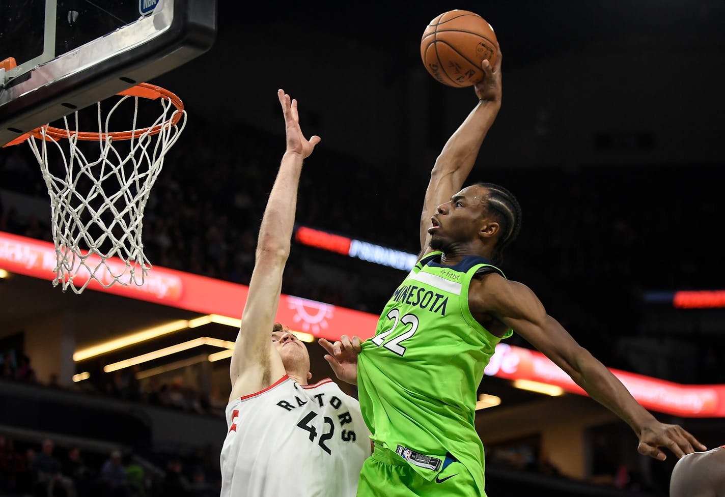 Minnesota Timberwolves forward Andrew Wiggins (22) went high to dunk the ball over Toronto Raptors center Jakob Poeltl (42) in the first quarter Saturday. ] AARON LAVINSKY &#xef; aaron.lavinsky@startribune.com The Minnesota Timberwolves played the Toronto Raptors on Saturday, Jan. 20, 2018 at Target Center in Minneapolis, Minn.