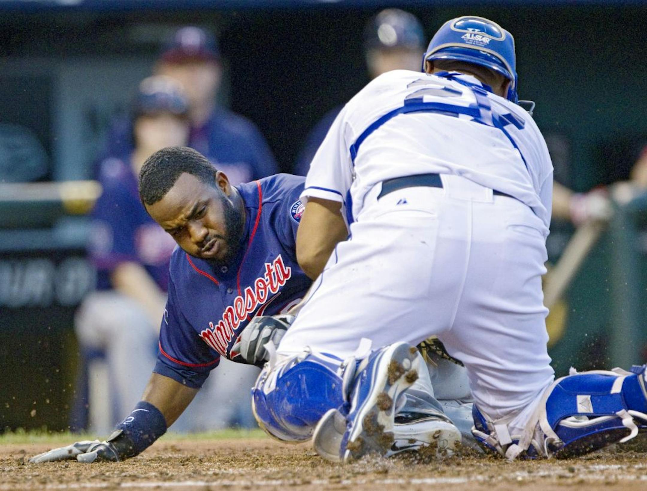 Kansas City Royals catcher Brayan Pena gets the ball in time to tag out Minnesota Twins' Denard Span, left, trying to stretch a triple into an inside-the-park home run in the fourth inning at Kauffman Stadium on Friday, June 3, 2011, in Kansas City, Missouri.