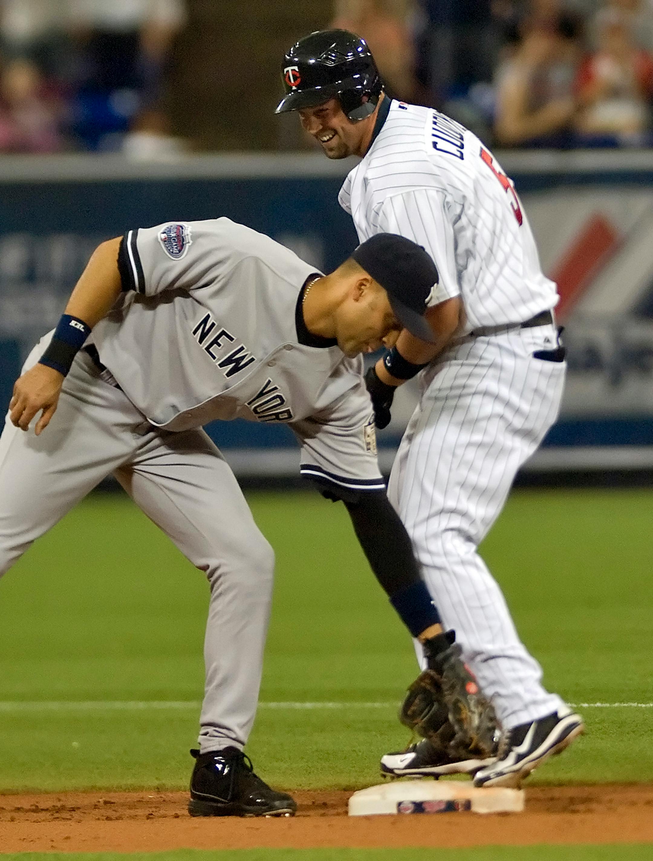 New York Yankees shortstop Derek Jeter (left) is late with the tag on the Minnesota Twins' Michael Cuddyer, after Cuddyer ended up at second base on his two-run single in the first inning. The Twins defeated the Yankees, 5-1, at the Metrodome in Minneapolis, Minnesota, Sunday, June 1, 2008.
