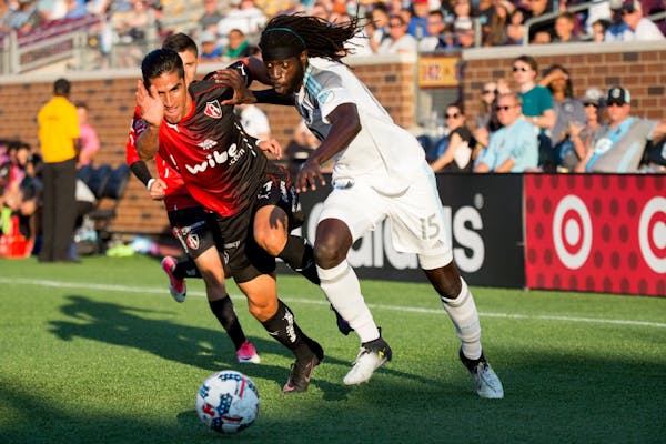 Minnesota United�s Ismaila Jome and Atlas� Jose Maduena fight for the ball during the first half on Saturday, July 15, 2017, at TCF Bank Stadium.