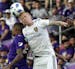 Orlando City's Stefano Pinho, left, and Real Salt Lake's Justen Glad battle for the ball on a header during the second half of an MLS soccer match, Su