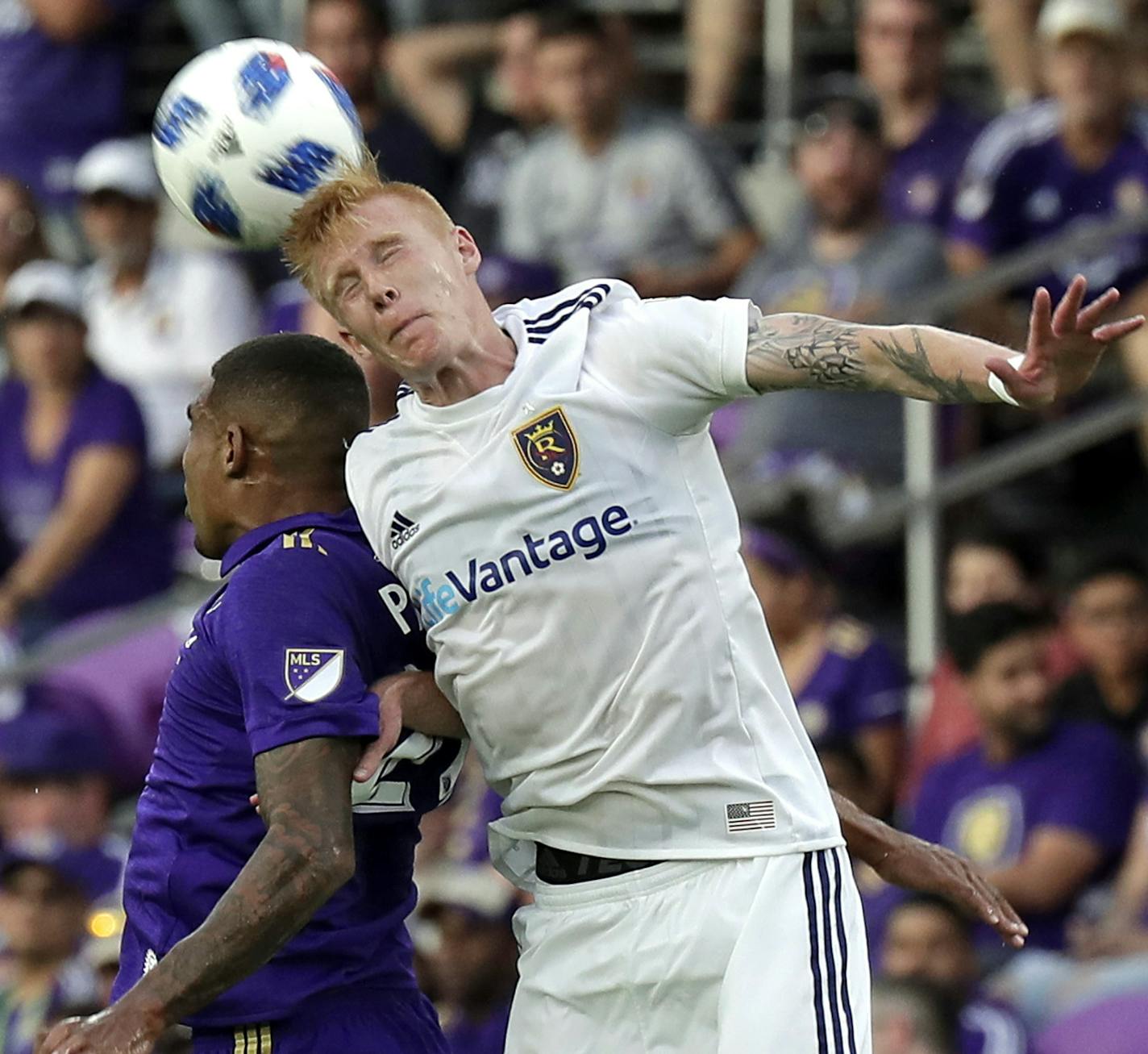 Orlando City's Stefano Pinho, left, and Real Salt Lake's Justen Glad battle for the ball on a header during the second half of an MLS soccer match, Sunday, May 6, 2018, in Orlando, Fla. (AP Photo/John Raoux) ORG XMIT: FLJR11