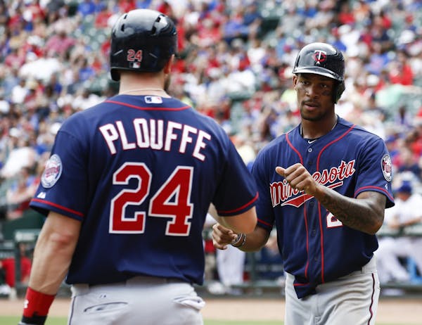 Minnesota Twins' Byron Buxton, right, is congratulated by Trevor Plouffe (24) after scoring the go-ahead run on a double by Eddie Rosario against the 