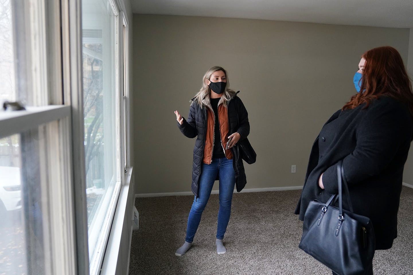 Rachel Miller, left, an agent with Kris Lindahl Real Estate, talked over the features of a home for sale with prospective first-time home buyer Claire Egan in New Hope.