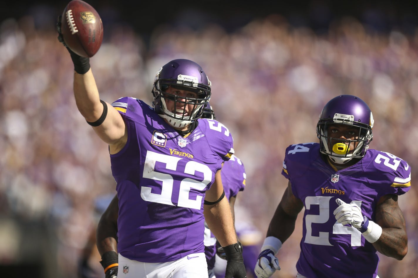 Vikings outside linebacker Chad Greenway (52) intercepted a fourth quarter pass and ran it back 91 yards for a touchdown Sunday afternoon. He was accompanied by Vikings cornerback Captain Munnerlyn (24) as he approached the end zone.