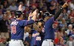 Minnesota Twins' Chris Gimenez (38), Byron Buxton (25) and Kennys Vargas, rear, celebrate scoring on a bases clearing double by Brian Dozier in the fi