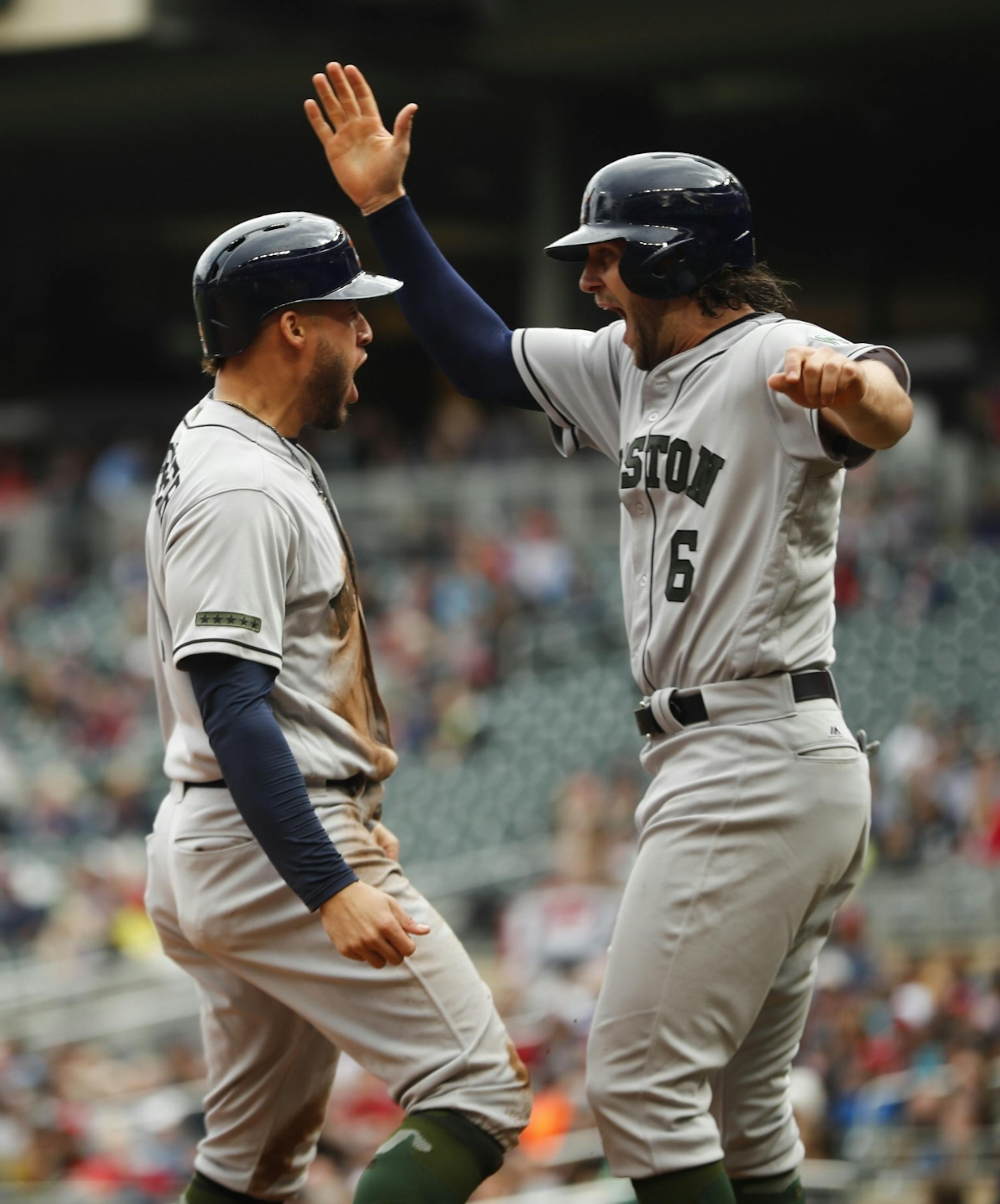 Houston's George Springer (4) and Jake Marisnick (6) celebrated after both scoring on a double by Josh Reddick (22) in the top of the 8th inning at Target Field in Minneapolis, Minn. on Monday, May 29, 2017. Houston score 11 points in the inning.