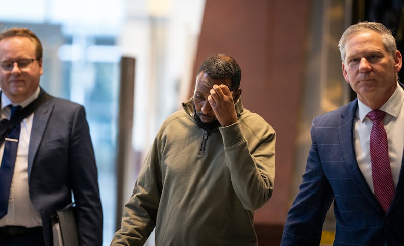 Defendant Said Shafii Farah, center, walks into United States District Court with attorneys Clayton Carlson, left, and Steve Schleicher, right, April 