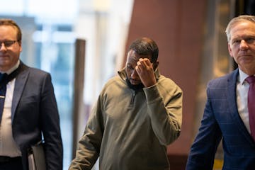 Defendant Said Shafii Farah, center, walks into United States District Court with attorneys Clayton Carlson, left, and Steve Schleicher, right, on Apr