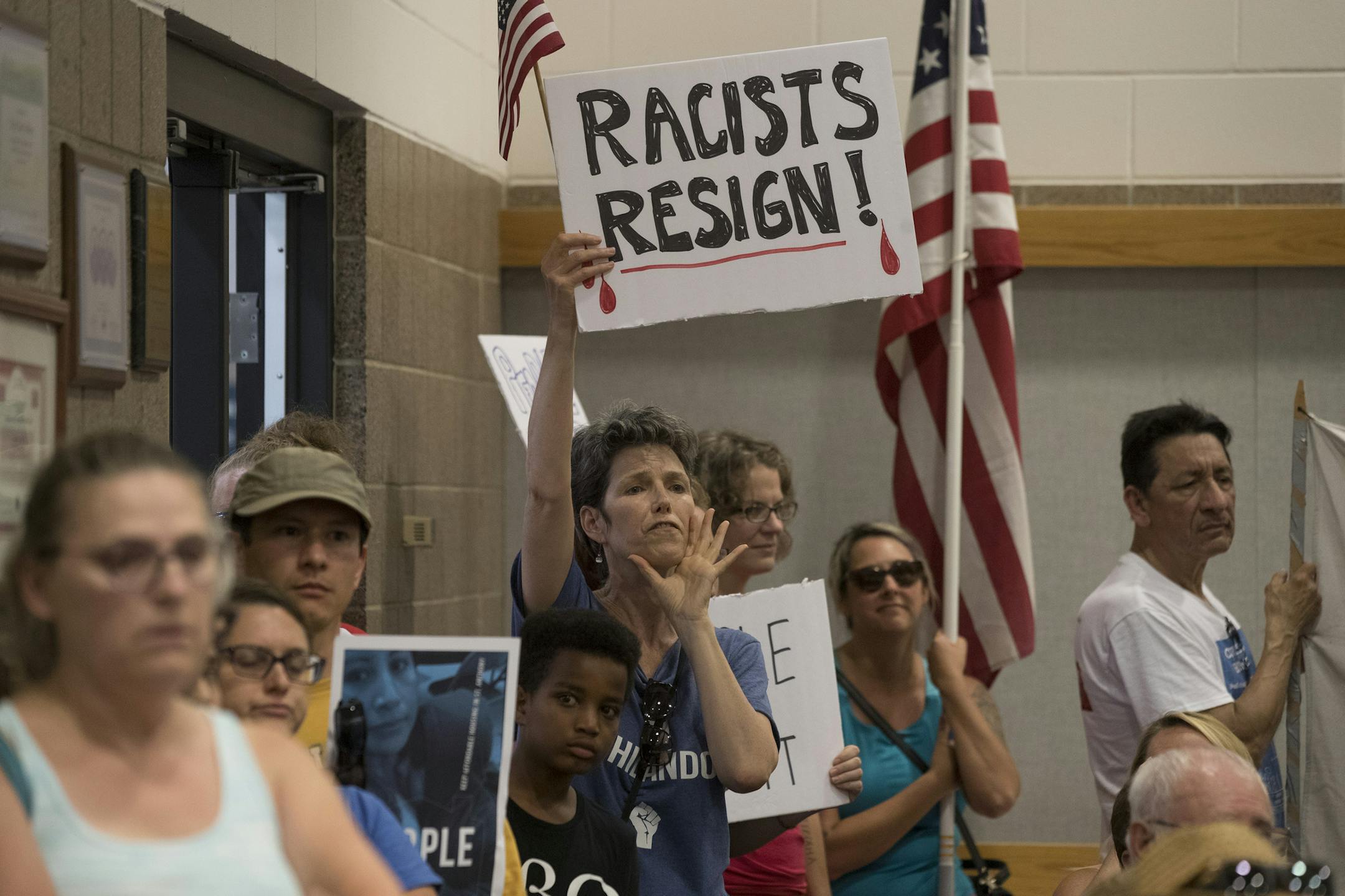 Residents of St. Anthony shouted for Mayor Jerry Faust and other council members to resign during a packed meeting . St. Anthony City Council pass a resolution to terminate its police contract with Falcon Heights at during Tuesday night's meeting at City Hall July 11, in St. Anthony, MN. ] JERRY HOLT ï jerry.holt@startribune.com